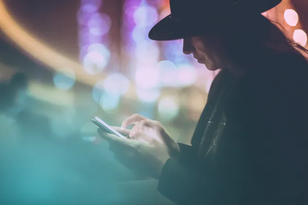 A confident dealer surrounded by casino chips inviting players to access their 77ABC account, reflecting quick and easy login options.